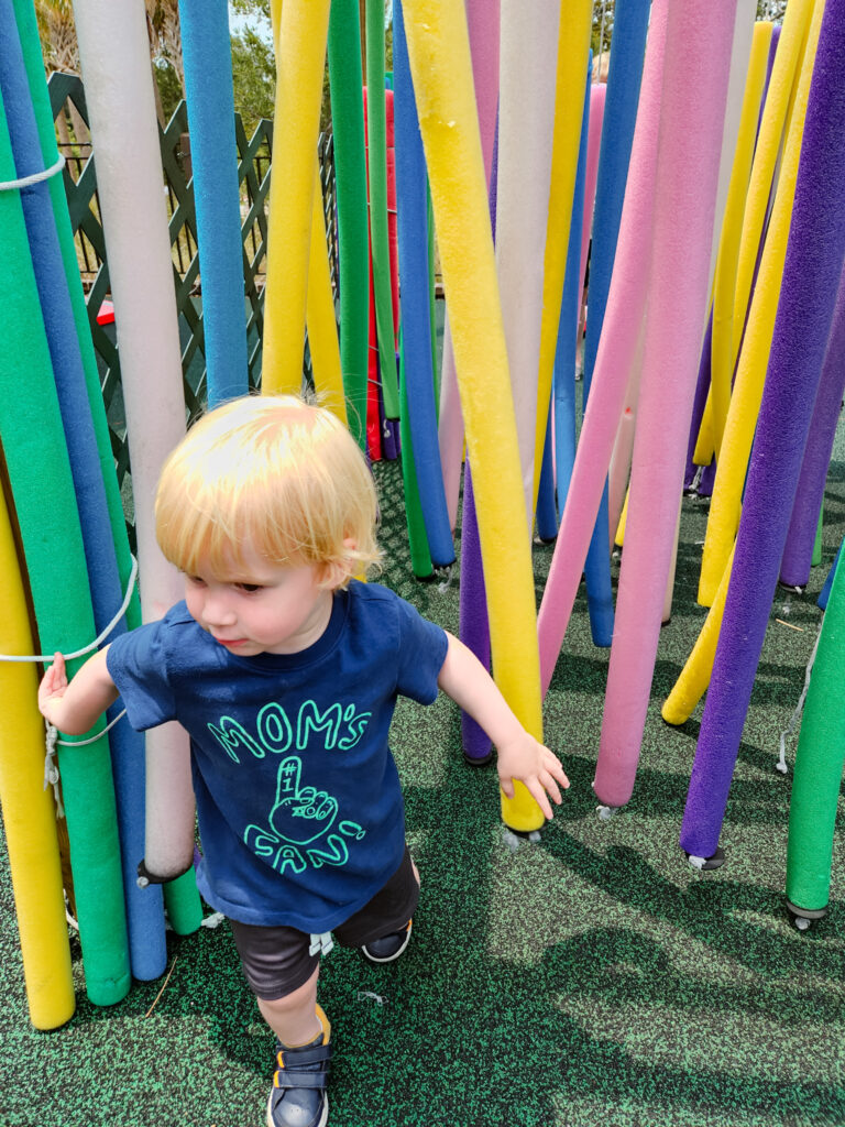 Callum in pool noodle forest at The Sandbox Children's Museum